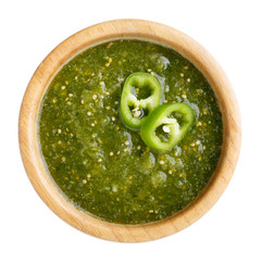 Tomatillo salsa verde. Bowl of spicy green sauce isolated on white table, mexican cuisine. Top view.