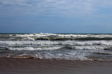 An image of the beach with a sea with waves