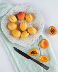 ripe apricots on a white table