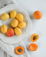 ripe apricots on a white table