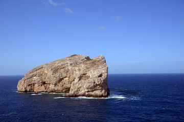 view of single rock in sea