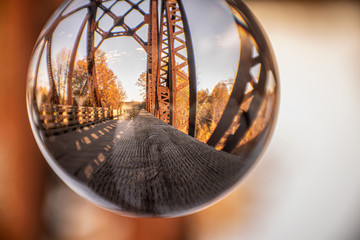 old rusted steel bridge in crystal ball 