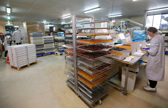 A worker prepare boxes of glace fruits and fruit jelly to export to England at the Cruzilles factory in Clermont-Ferrand