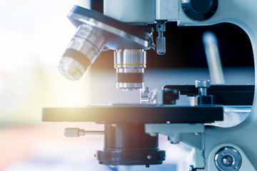 Closeup microscope lenses on sample slide. Biology science and medical concept.