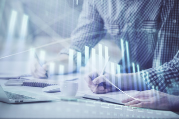 Multi exposure of forex chart with man working on computer on background. Concept of market analysis.