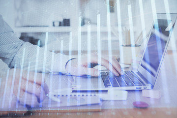 Multi exposure of stock market chart with man working on computer on background. Concept of financial analysis.