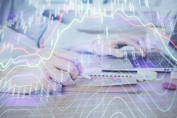 Multi exposure of financial graph with man works in office on background. Concept of analysis.