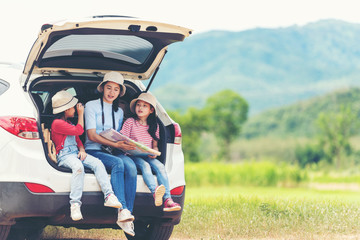 Group asian family children checking map and pointing on the car adventure and tourism for...
