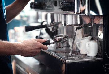 Fototapeta na wymiar Close up of barista hands preparing cappuccino.