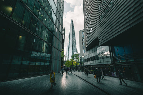 LONDON - APRIL 26, 2018: People walking towards the Shard building in London
