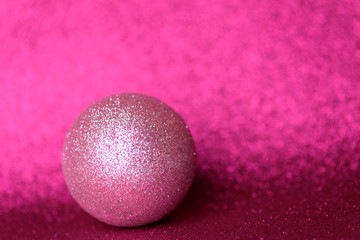  Pink christmas decorations on shiny pink background. Christmas background