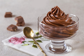 chocolate mousse cream dessert in a glass vase on a light background