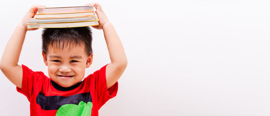 Back to school, Asian student boy kid stack book balanced on head