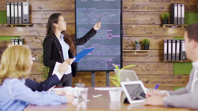 Young business woman in suit having a successful presentation