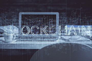 Multi exposure of blockchain theme hologram and table with computer background. Concept of bitcoin crypto currency.