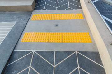 Fototapeta premium Concert ramp way with stainless steel handrail with disabled sign for support wheelchair disabled people. Ramp way to support wheelchair disabled people.