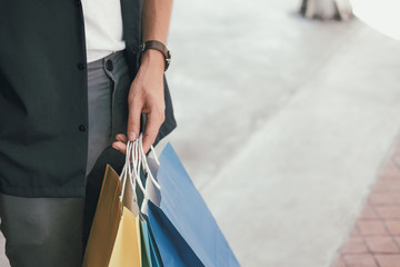 man with shopping bags at shopping mall.