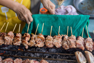 Barbecue pork Toast grill or Toast pork with Thai garnish nutrition preparation for cooking. Thai food, Street food. Pork satay grilling on stove or Thai style roasted pork at the market.