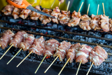 Barbecue pork Toast grill or Toast pork with Thai garnish nutrition preparation for cooking. Thai food, Street food. Pork satay grilling on stove or Thai style roasted pork at the market.