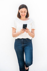 older woman holding mobile phone by white background