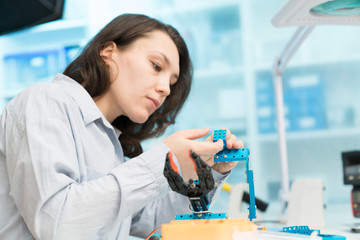 Student woman in robotics laboratory working  on project mechatronics