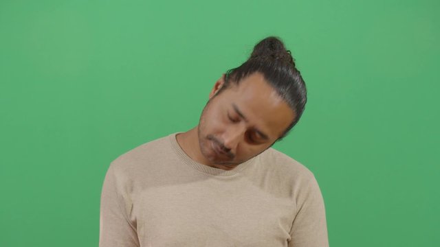 Adult Man Head Turning Like A Sign Of Stress Or Trying To Relax A Tired Body. Studio Isolated Shot Against Green Screen Background