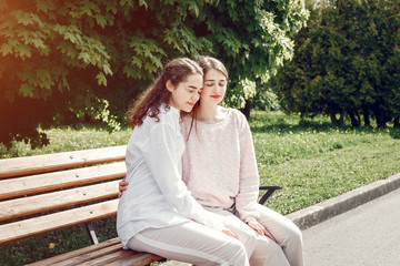 Beautiful two sisters. Women in a summer park