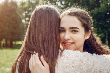 Beautiful two sisters. Women in a summer park