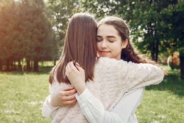 Fototapeta premium Beautiful two sisters. Women in a summer park