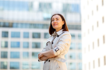 older woman standing outside with arms crossed