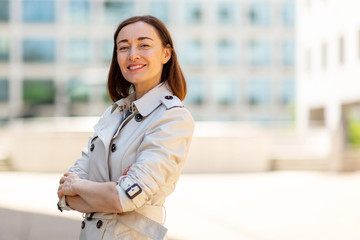 confident older woman smiling outside in city