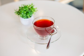 rose tea in cup on white table, red tea