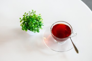 rose tea in cup on white table, red tea