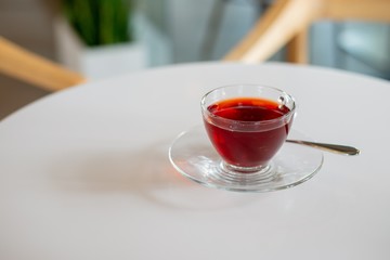 rose tea in cup on white table, red tea