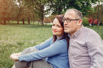 Couple in a forest. Adult pair walking. Lady in a blue shirt