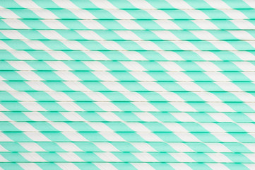 background of pile of paper striped white and green drinking straws for party. space for text
