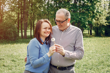 Couple in a forest. Adult pair walking. Lady in a blue shirt