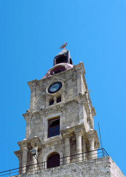 the historic roloi medieval clock tower in rhodes town against a blue sky