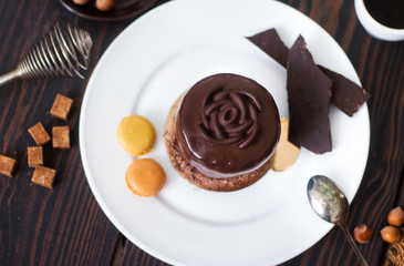 Chocolate cake on a white plate close-up.