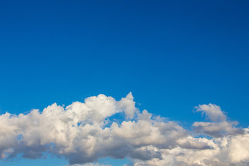 White cumulus clouds on blue sky background, copy space_