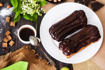 Homemade eclairs in chocolate icing. Cooking of eclairs in the home kitchen.