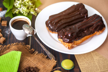 Homemade eclairs in chocolate icing. Cooking of eclairs in the home kitchen.