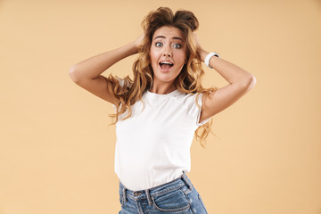 Portrait of joyous woman in casual clothes wondering and touching her hair