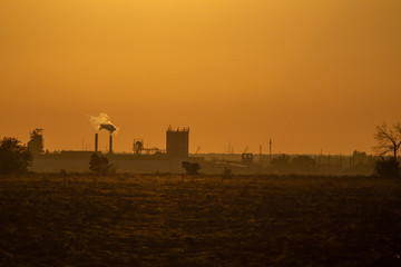 Fototapeta premium landscape with factory silhouette in sunset
