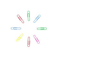 multicolored paper clips in the form of a circle on white background. Decorative paper clips in pink, yellow, green, red and blue colors. Multicolored paper clips with space for text