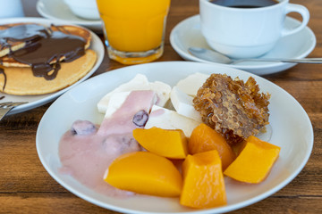 Breakfast of many dishes and drinks on a wooden table, closeup. Food concept