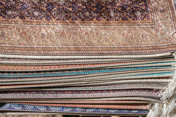 Traditional carpets for sell at a street market stall in Bodrum, Turkey. Closeup