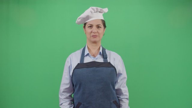 Bad Smeling Hands Expressed By A Woman Cook. Studio Isolated Shot Against Green Screen Background