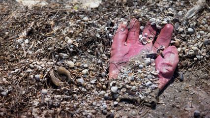 Rubber glove on beach line, close up