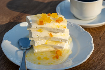Curd cheese with lemon jam and cup coffee on table. Breakfast concept